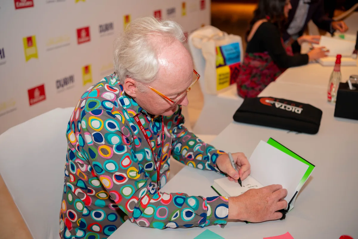 Toby Walsh, who gave the IWM Digital Humanism Fellowship Lecture in 2026, signing copies of his book.